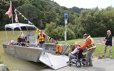 J Barry Ferguson boarding namesake on his 92nd birthday Mahurangi River picnic excursion