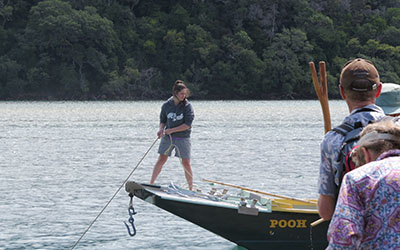 Caitlin Owston Doyle warping the barge Pooh into position at the Wenderholm Jetty, 2014