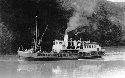 Steamboat Omana steaming upstream in the Mahurangi River, Tudor Collins