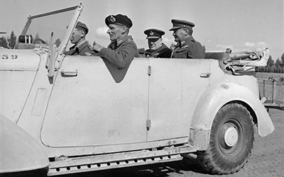 Winston Churchill inspecting units of the New Zealand Division with, clockwise, Bernard Freyberg, Bernard Montgomery; John Poston, driver